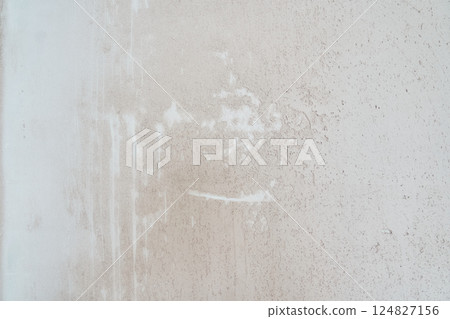 Background with the texture of an old plastered wall. Uneven background with the texture of decorative plaster exposed to atmospheric influences. Rough wall with space for copying. High quality photo 124827156