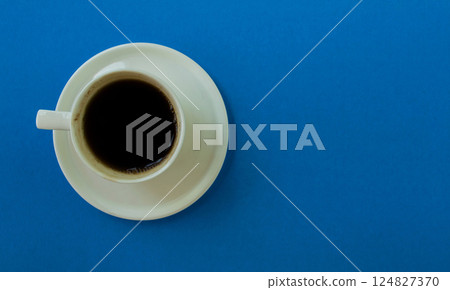 Cup of coffee on a blue background. Cup of coffee on a blue background. 124827370