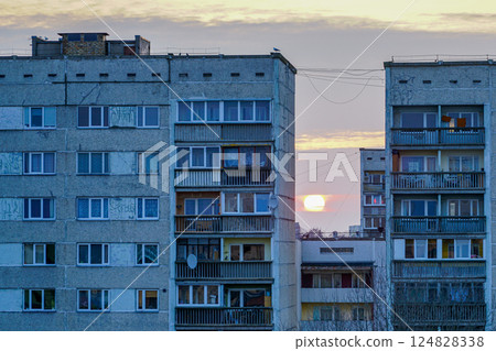 Sunset in an urban suburban environment of dilapidated weathered apartment buildings 124828338