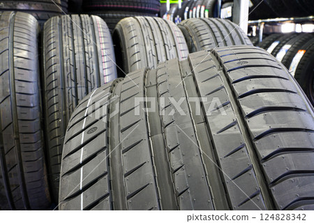 Closeup of the tread of a wide large size high-performance summer tire Closeup of the tread of a wide large size high-performance summer tire 124828342
