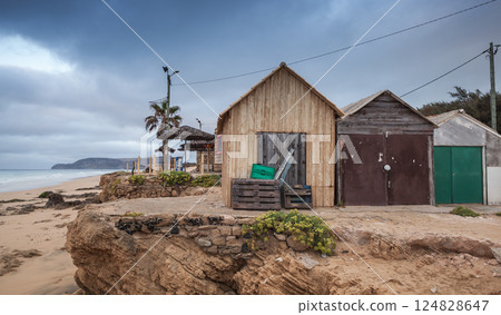 Rustic wooden huts sit serenely at the edge of cliff/ Porto Santo 124828647