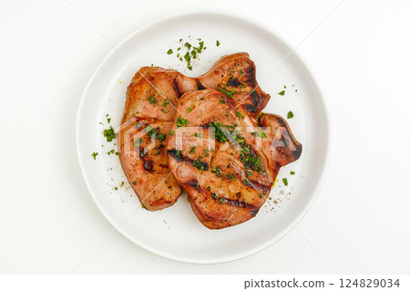 Grilled pork on a plate with herbs, a delicious and savory dinner dish to enjoy Grilled pork on a plate with herbs, a delicious and savory dinner dish to enjoy 124829034