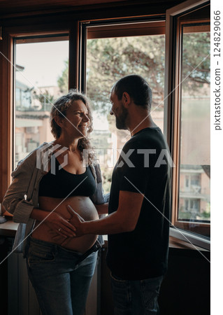 Expectant Couple Shares a Joyful Moment at Home 124829066