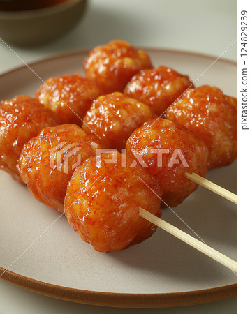Delicious skewer snack with sauce on plate, an Asian cuisine appetizer for tasty dining Delicious skewer snack with sauce on plate, an Asian cuisine appetizer for tasty dining 124829239