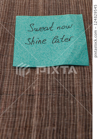 Motivational note placed on fabric reminds to work hard for future success 124829545