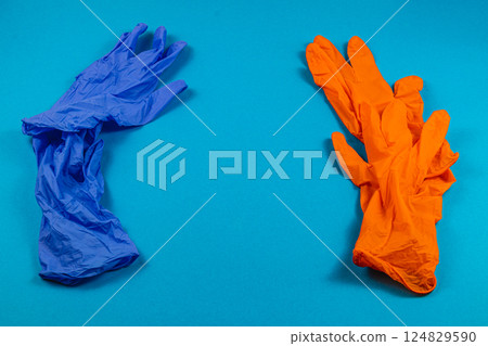 Colorful rubber gloves on a blue background 124829590