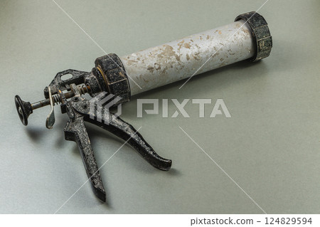 Tool for sealing and applying adhesive in workshop setting 124829594