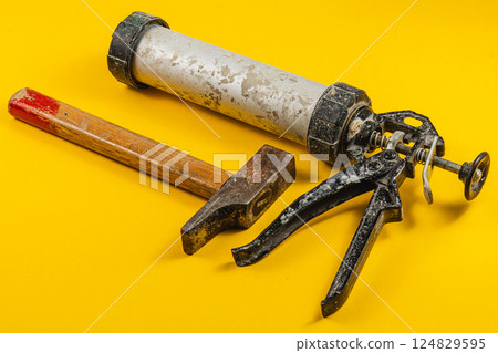 Tools for construction projects on a bright yellow surface Tools for construction projects on a bright yellow surface 124829595