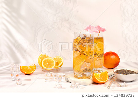 Diet vegan cocktail with chia seeds, orange, lime, violet and ice. Detox diet and weight loss concept. Summer party and healthy lifestyle advertising. Summer banner and screen template. 124829722