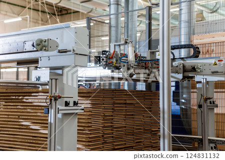 Production line of the wooden floor factory. CNC automatic woodworking machine. Production line of the wooden floor factory. CNC automatic woodworking machine. 124831132