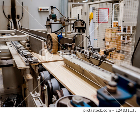 Production line of the wooden floor factory. CNC automatic woodworking machine. 124831135