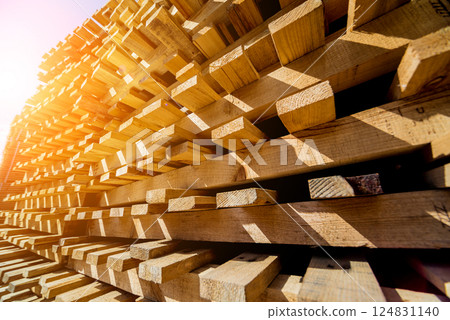 Stack of natural rough wooden boards. Wooden boards, lumber, industrial wood. 124831140