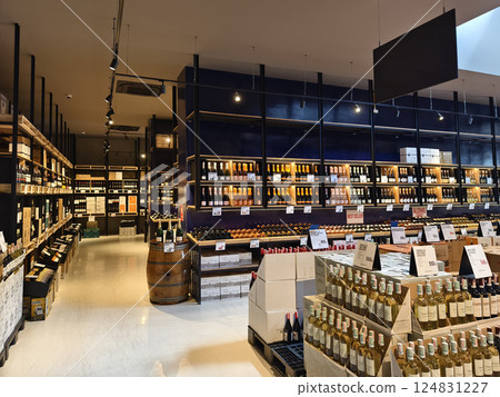 A spacious shop warehouse that contains numerous wine bottles and boxes A spacious shop warehouse that contains numerous wine bottles and boxes 124831227
