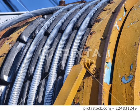 A large wooden spool of high-voltage electric wires is located on the road A large wooden spool of high-voltage electric wires is located on the road 124831249