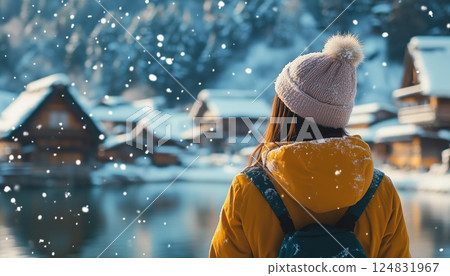 Adventurous Young Woman Delighting In Snowy Winter Wonderland Of Shirakawa-Go, Embracing The Beauty Of The Season With Joy And Wonder. 124831967