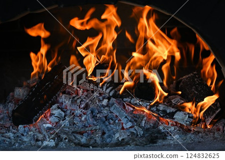 Pizza baking in a wood-fired pizza oven - food background material Pizza baking in a wood-fired pizza oven - food background material 124832625