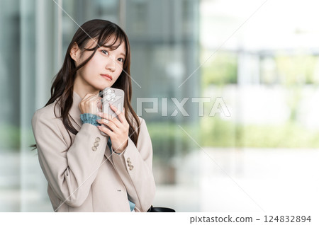 Worried, thinking, confused young Asian business woman (business, employment, quitting job, changing jobs) Worried, thinking, confused young Asian business woman (business, employment, quitting job, changing jobs) 124832894