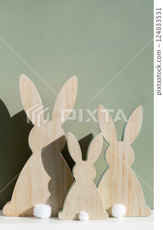 Minimalistic creative Easter concept. Two Easter bunnies under symbolic roof on green background. Celebration Easter holiday at home with family. Poster or greeting card Minimalistic creative Easter concept. Two Easter bunnies under symbolic roof on green background. Celebration Easter holiday at home with family. Poster or greeting card 124833531