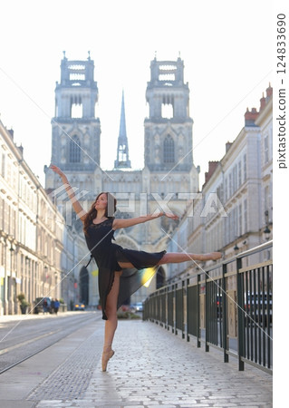 Ballerina performs arabesque on city street Ballerina performs arabesque on city street 124833690