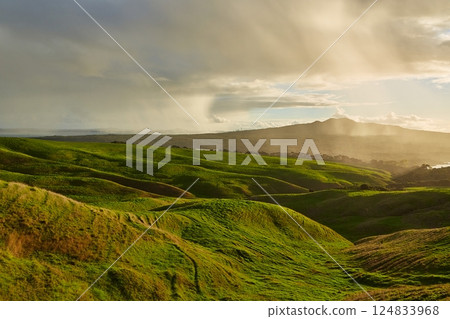 Green New Zealand landscape with coming rain Green New Zealand landscape with coming rain 124833968