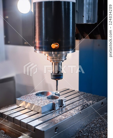 CNC milling machine processing on steel with cooling CNC milling machine processing on steel with cooling 124834289