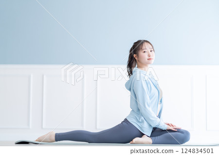 A young woman stretching with a flexible body 124834501