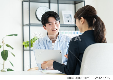 A young man consulting with a planner 124834629