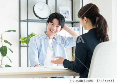 A young man consulting with a planner 124834631