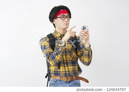 Akihabara-style man using a smartphone on a white background 124834707