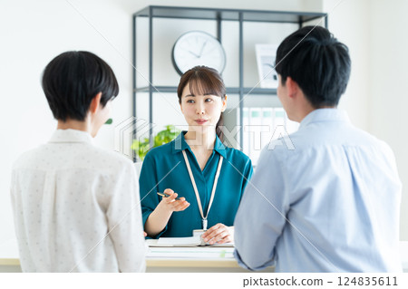 A planner consulting with a young couple A planner consulting with a young couple 124835611