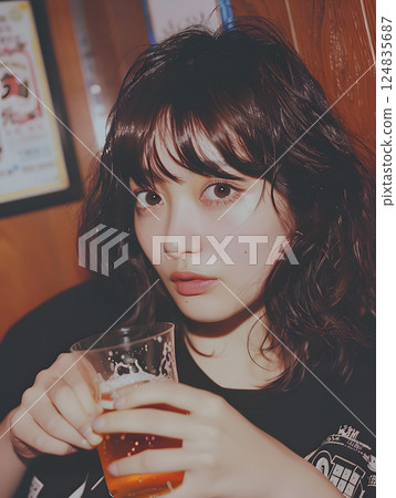 Asian woman portrait with beer, relaxing atmosphere in izakaya or bar 124835687
