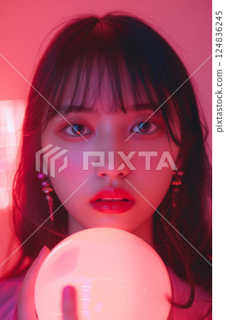 Mysterious Asian woman holding a glowing crystal ball 124836245