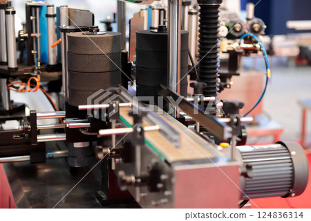 automatic bottle labeling machine close up 124836314