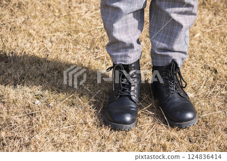 A girl's feet in boots: Autumn/winter image A girl's feet in boots: Autumn/winter image 124836414