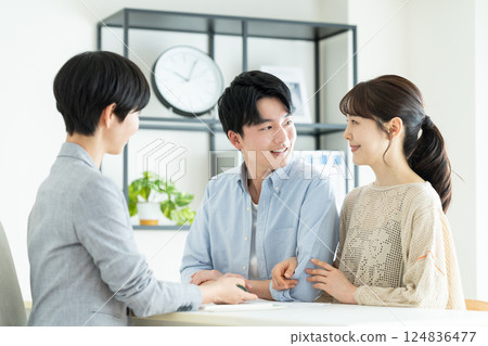Young couple consulting planner Young couple consulting planner 124836477