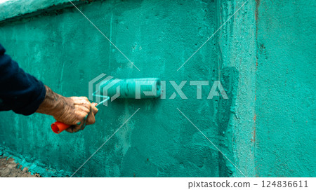 Roller Brush Painting,Paint the fence wall in summer bright blue. Roller Brush Painting,Paint the fence wall in summer bright blue. 124836611