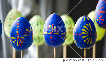 Brightly painted Easter eggs on display, showcasing intricate patterns and vibrant colors. 124836777