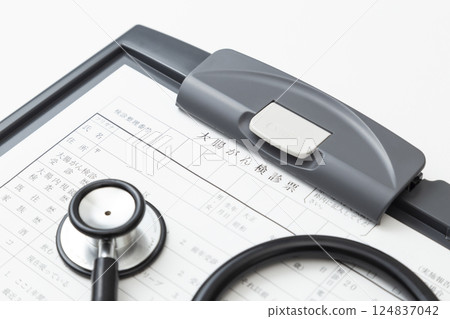 Colon cancer screening card and stethoscope on white background Colon cancer screening card and stethoscope on white background 124837042