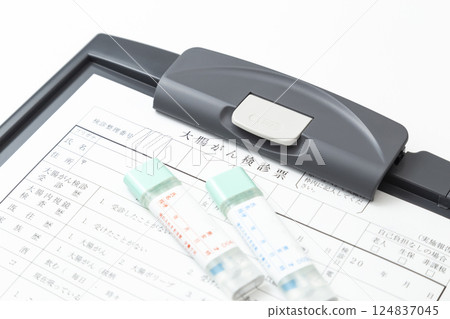 Colon cancer screening card and stool test kit on white background 124837045