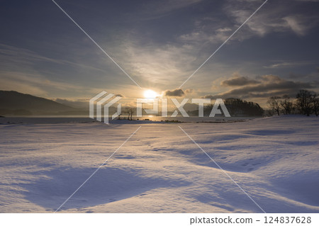 Sunrise over a frozen lake Sunrise over a frozen lake 124837628