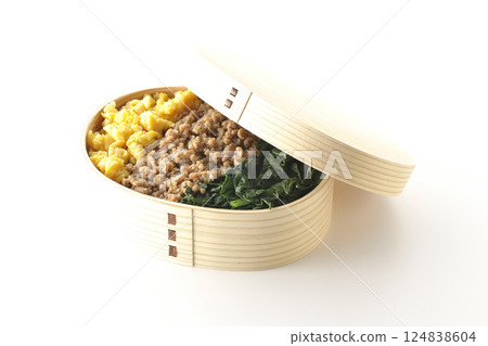 Three-color bento box with egg, meat, and spinach photographed on white background Three-color bento box with egg, meat, and spinach photographed on white background 124838604