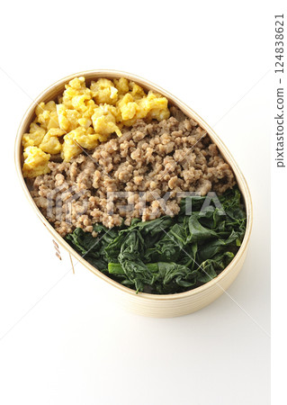 Three-color bento box with egg, meat, and spinach photographed on white background Three-color bento box with egg, meat, and spinach photographed on white background 124838621