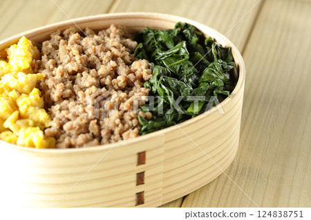 Three-color bento box with egg, meat, and spinach Three-color bento box with egg, meat, and spinach 124838751