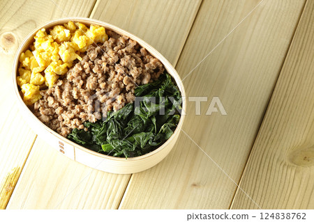 Three-color bento box with egg, meat, and spinach Three-color bento box with egg, meat, and spinach 124838762
