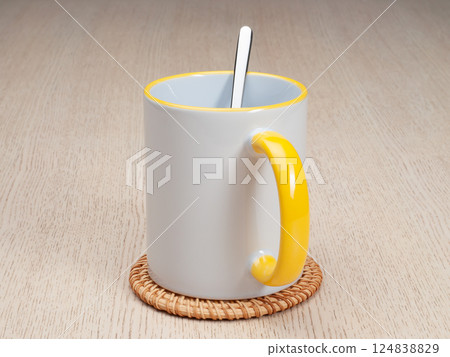 Two-tone 11oz mug on the mug coaster on the table. Mug with tea spoon. Mug with yellow handle and inner part. Two-tone 11oz mug on the mug coaster on the table. Mug with tea spoon. Mug with yellow handle and inner part. 124838829