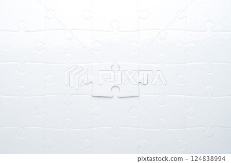 Concept for problem-solving, teamwork, solutions, or missing connections. White jigsaw puzzle on a vibrant blue background with one missing piece. Minimalist composition with copy space. 124838994