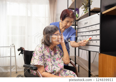 Confused Asian Senior Man With Dementia Looking At Wall Calendar. 124839911