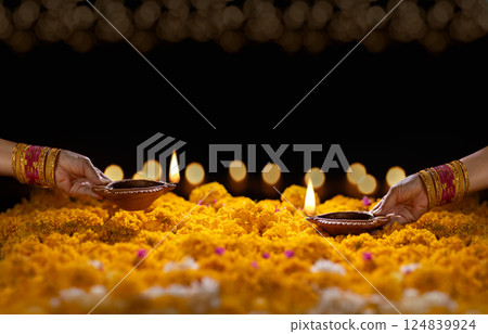 Clay diya lamps lit during diwali celebration, Diwali, or Dipawali, is India's biggest and most important holiday. 124839924