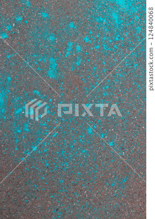 Multi-colored dry blue paints on gray asphalt. Powder coating at holi festival. Vertical photo. 124840068