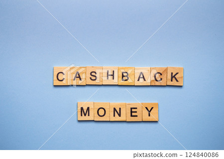 Finance concept. On a blue surface, wooden cubes with the inscription cashback money. 124840086